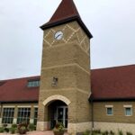 germantown village hall clock tower building with tan bricks