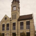 cream brick building with a clock tower in oconomowoc wisconsin