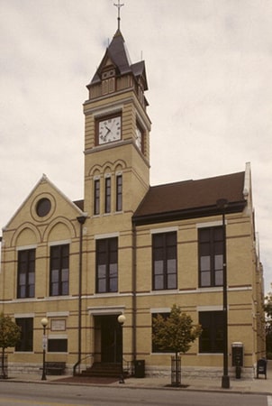 cream brick building with a clock tower in oconomowoc wisconsin